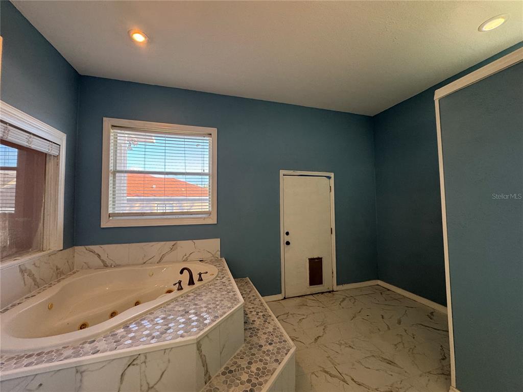 12349 Wasatch Court New Port Richey, FL 34654 - Photo 15 of 34 a bathroom with a bathtub and a window