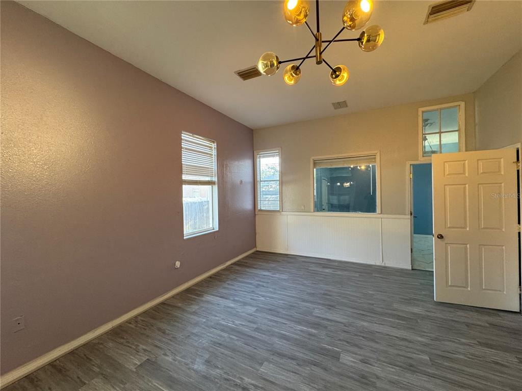 12349 Wasatch Court New Port Richey, FL 34654 - Photo 20 of 34 a view of an empty room with window and wooden floor