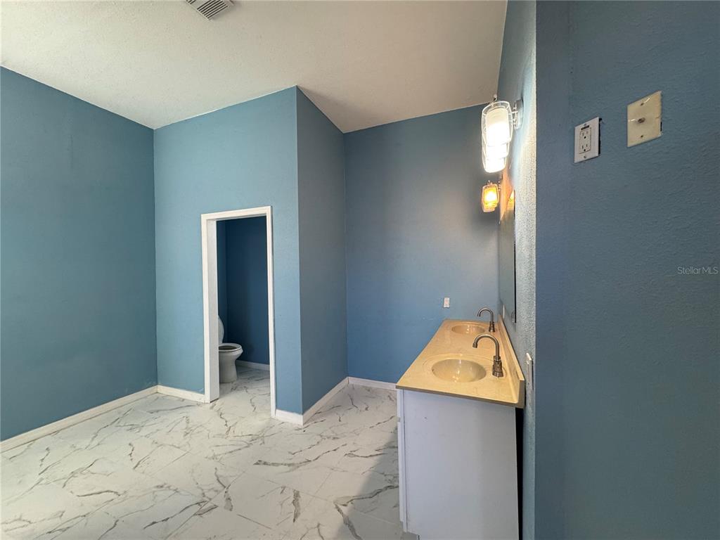 12349 Wasatch Court New Port Richey, FL 34654 - Photo 22 of 34 a bedroom with a bed and a dresser