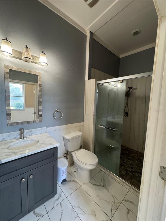 12349 Wasatch Court New Port Richey, FL 34654 - Photo 23 of 34 a bathroom with a double vanity sink toilet and shower