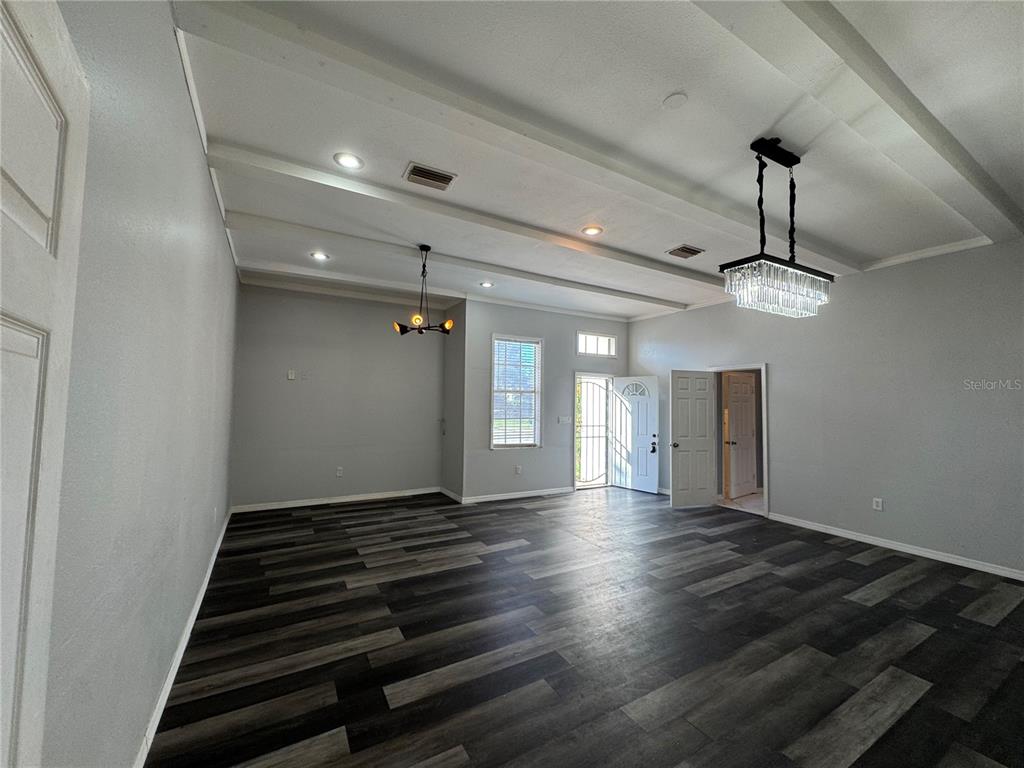 12349 Wasatch Court New Port Richey, FL 34654 - Photo 24 of 34 a view of an empty room with wooden floor and windows