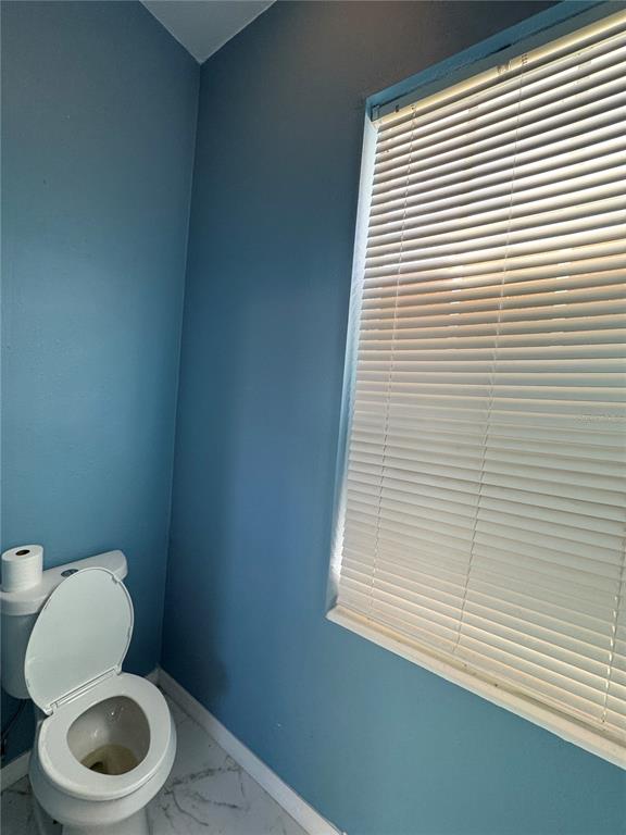 12349 Wasatch Court New Port Richey, FL 34654 - Photo 29 of 34 a bathroom with a toilet and a window