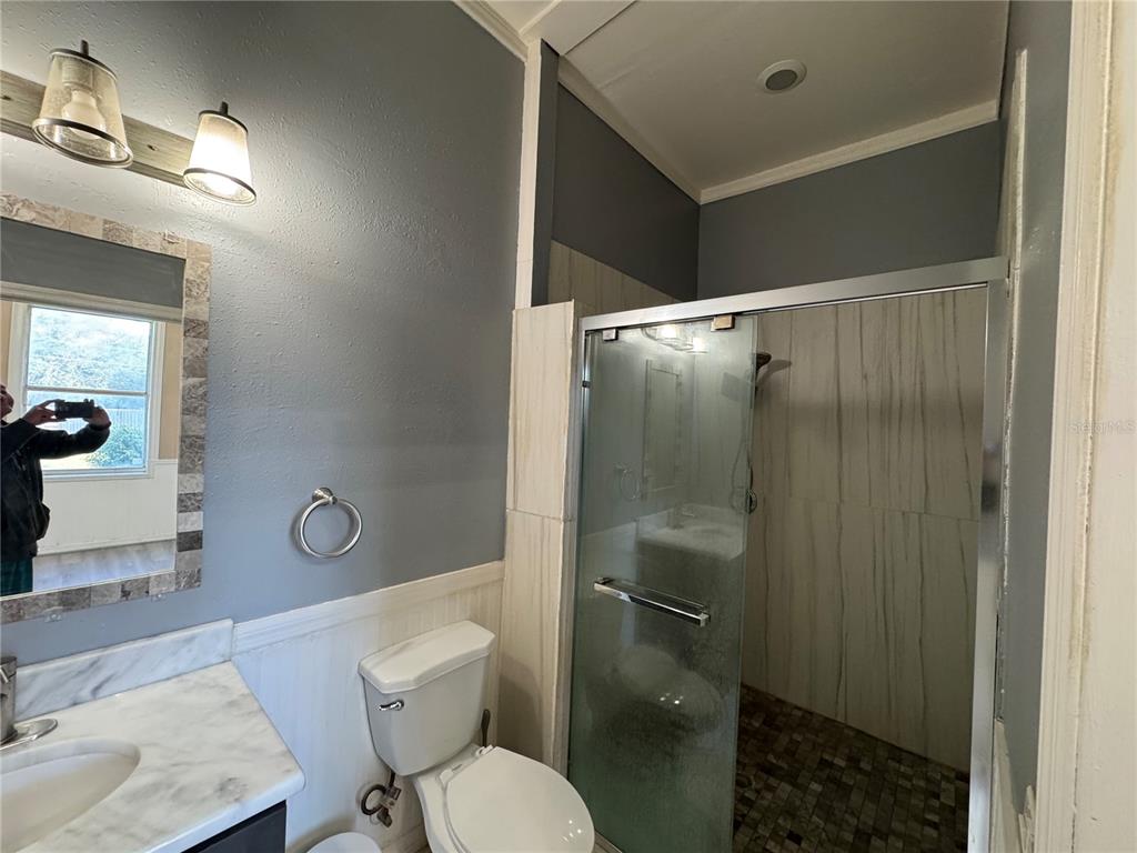 12349 Wasatch Court New Port Richey, FL 34654 - Photo 31 of 34 a bathroom with a toilet a sink and shower