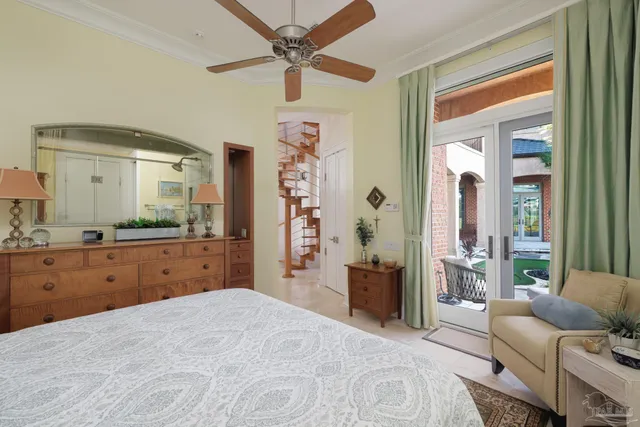 a bedroom with furniture and a large window