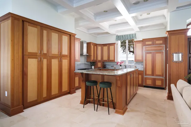 a kitchen with stainless steel appliances granite countertop a sink a counter space and a window
