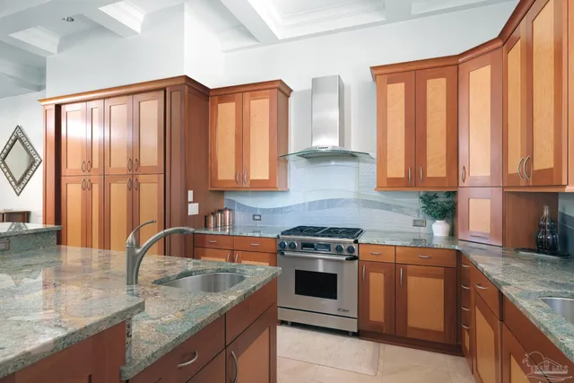 a kitchen with stainless steel appliances granite countertop a sink stove and cabinets