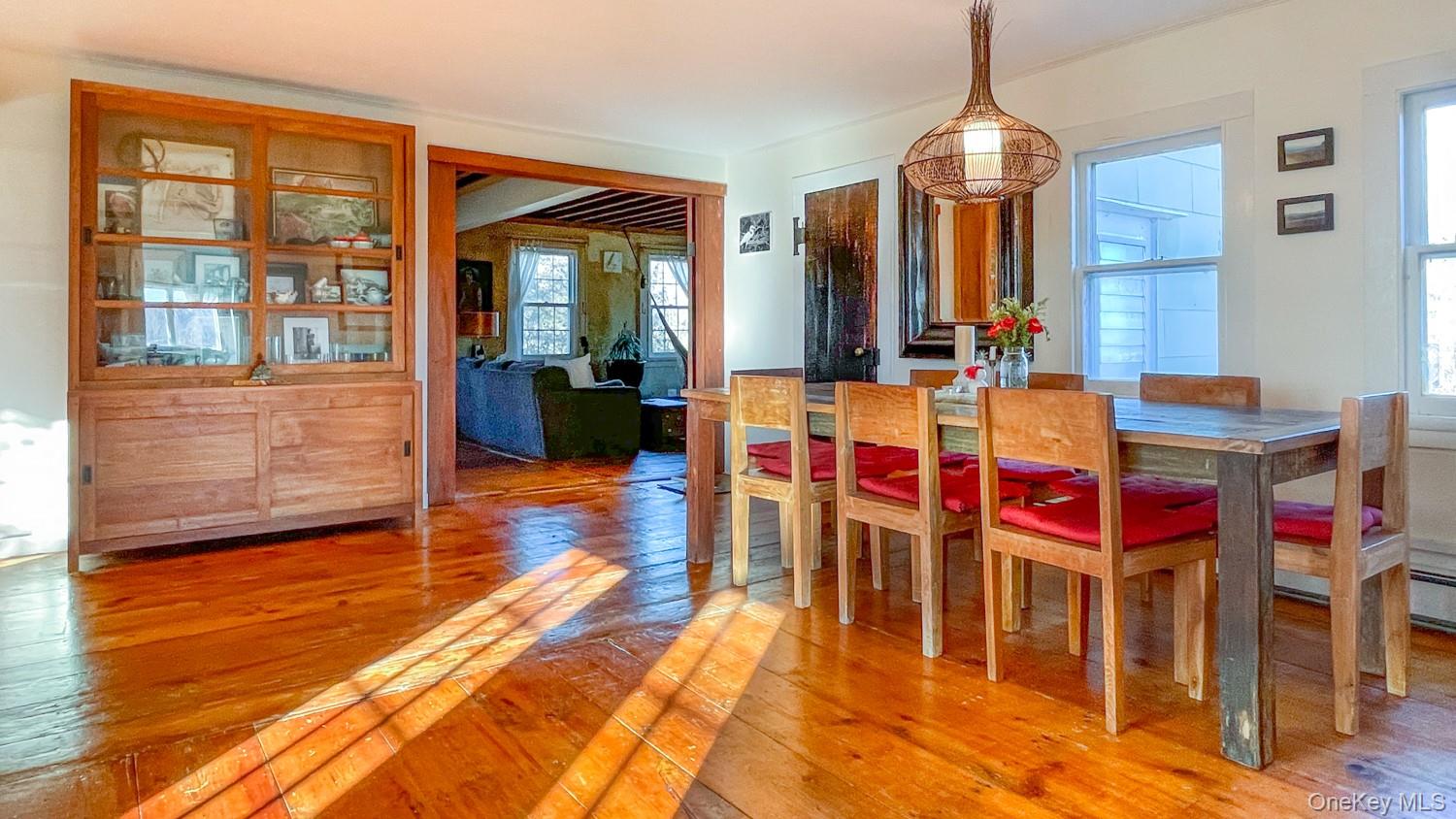 1201 Bruynswick Road Gardiner, NY 12525 - Photo 4 of 30 a dining room with wooden floor and large windows
