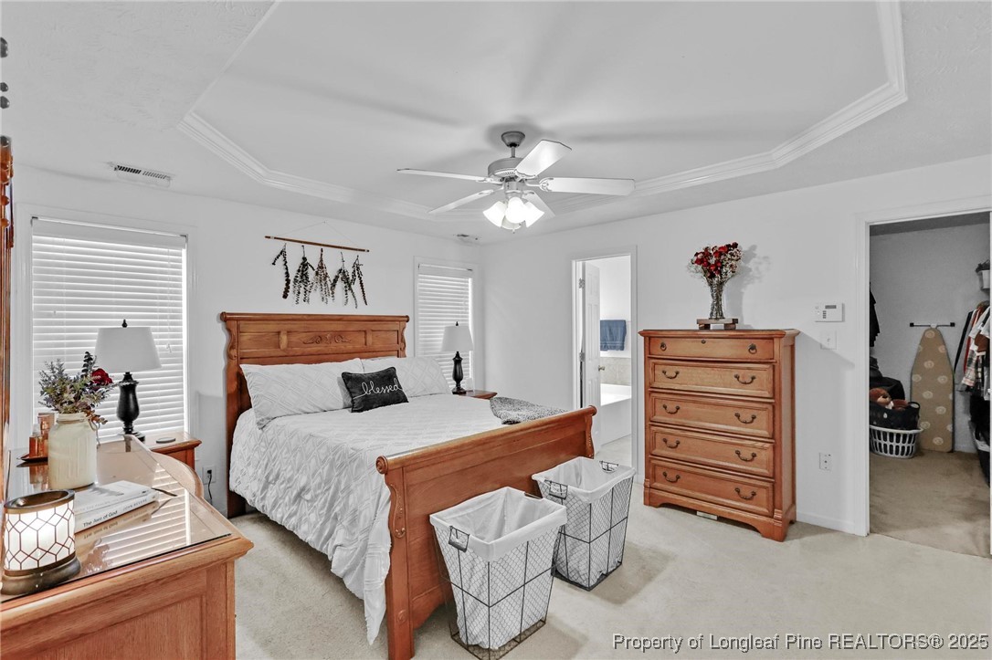 6657 Hillbrook Road Hope Mills, NC 28348 - Photo 14 of 50 a bedroom with a bed and a chandelier