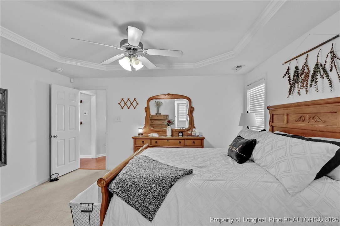 6657 Hillbrook Road Hope Mills, NC 28348 - Photo 18 of 50 a bedroom with a bed and wooden floor
