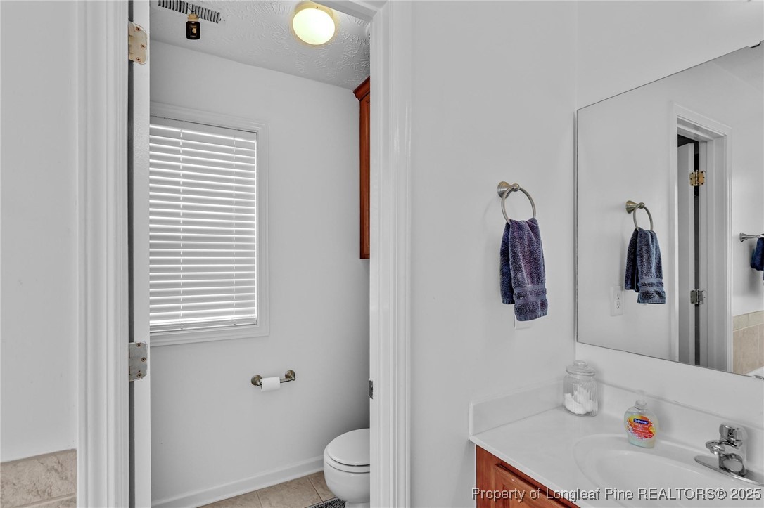6657 Hillbrook Road Hope Mills, NC 28348 - Photo 20 of 50 a bathroom with a sink toilet and shower