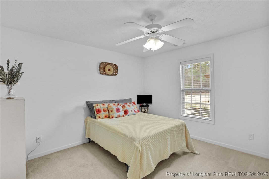 6657 Hillbrook Road Hope Mills, NC 28348 - Photo 23 of 50 a bedroom with a bed and a window