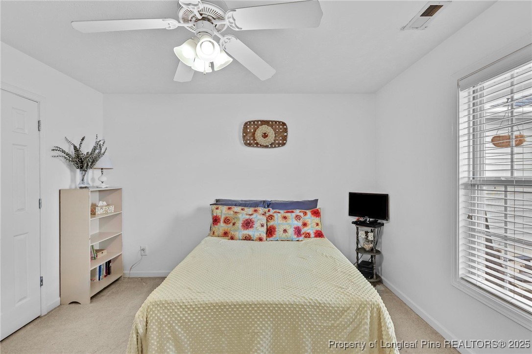 6657 Hillbrook Road Hope Mills, NC 28348 - Photo 24 of 50 a bedroom with a bed and a window