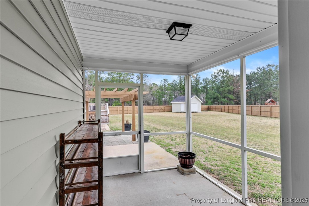 6657 Hillbrook Road Hope Mills, NC 28348 - Photo 35 of 50 a view of a porch with furniture and wooden roof