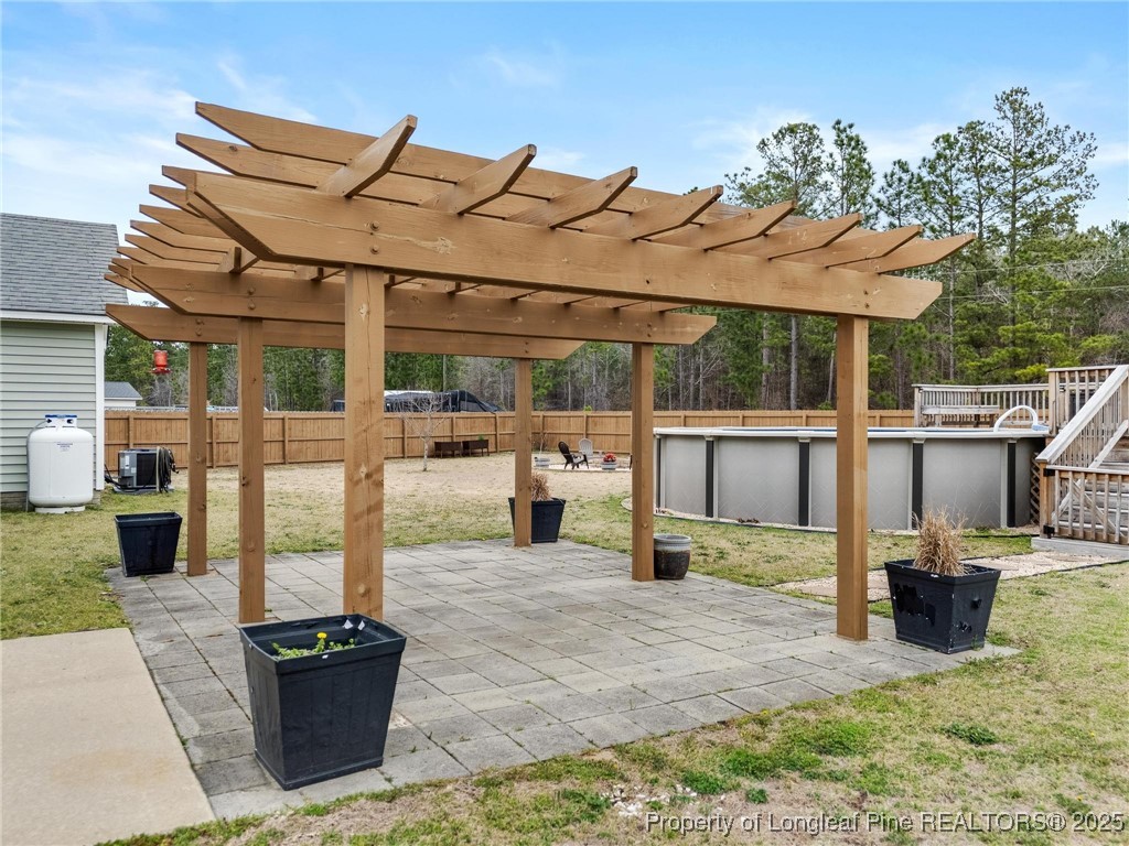 6657 Hillbrook Road Hope Mills, NC 28348 - Photo 40 of 50 a view of a patio with table and chairs potted plants