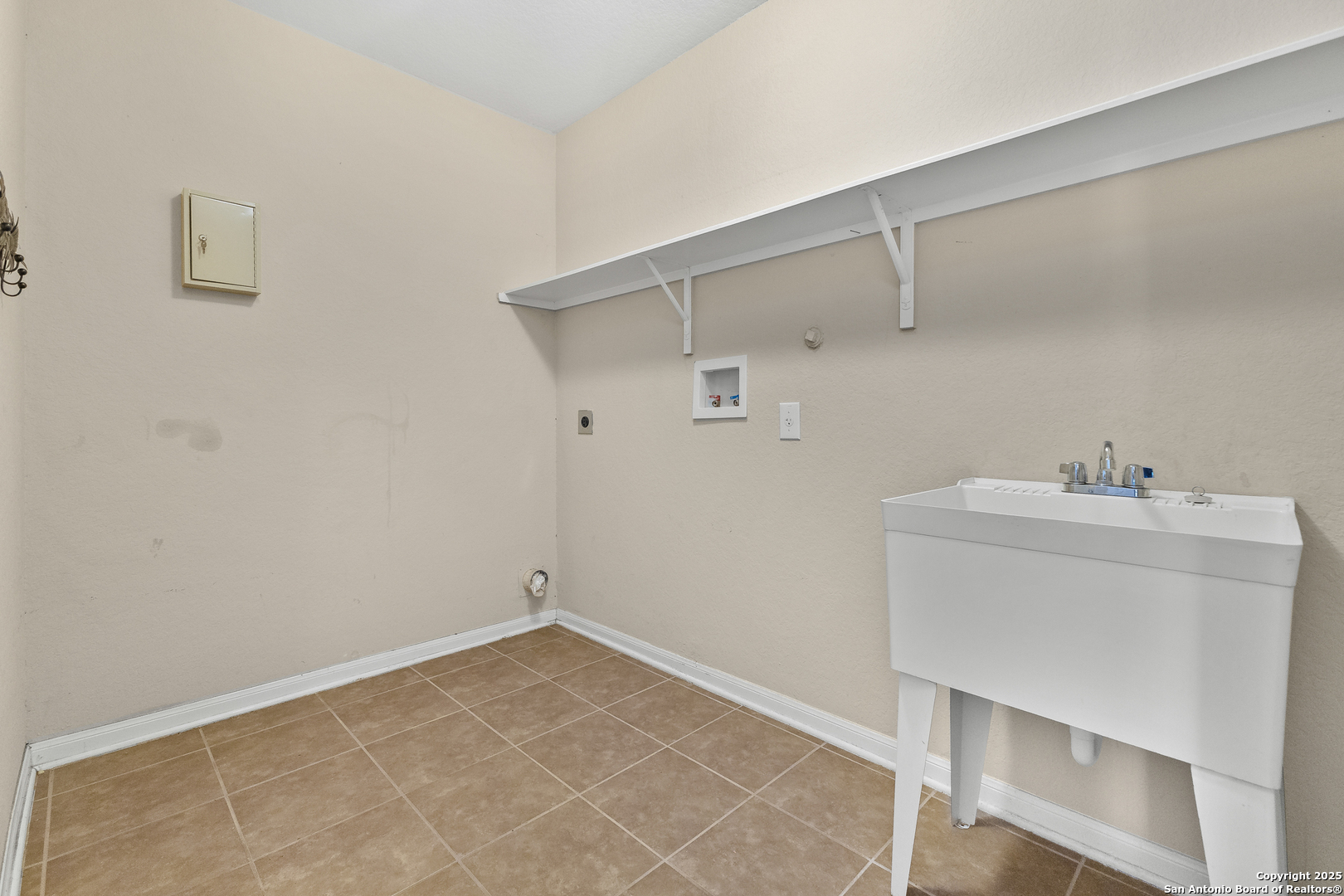 4402 Rucker Park Converse, TX 78109 - Photo 22 of 25 a utility room with cabinets washer and dryer