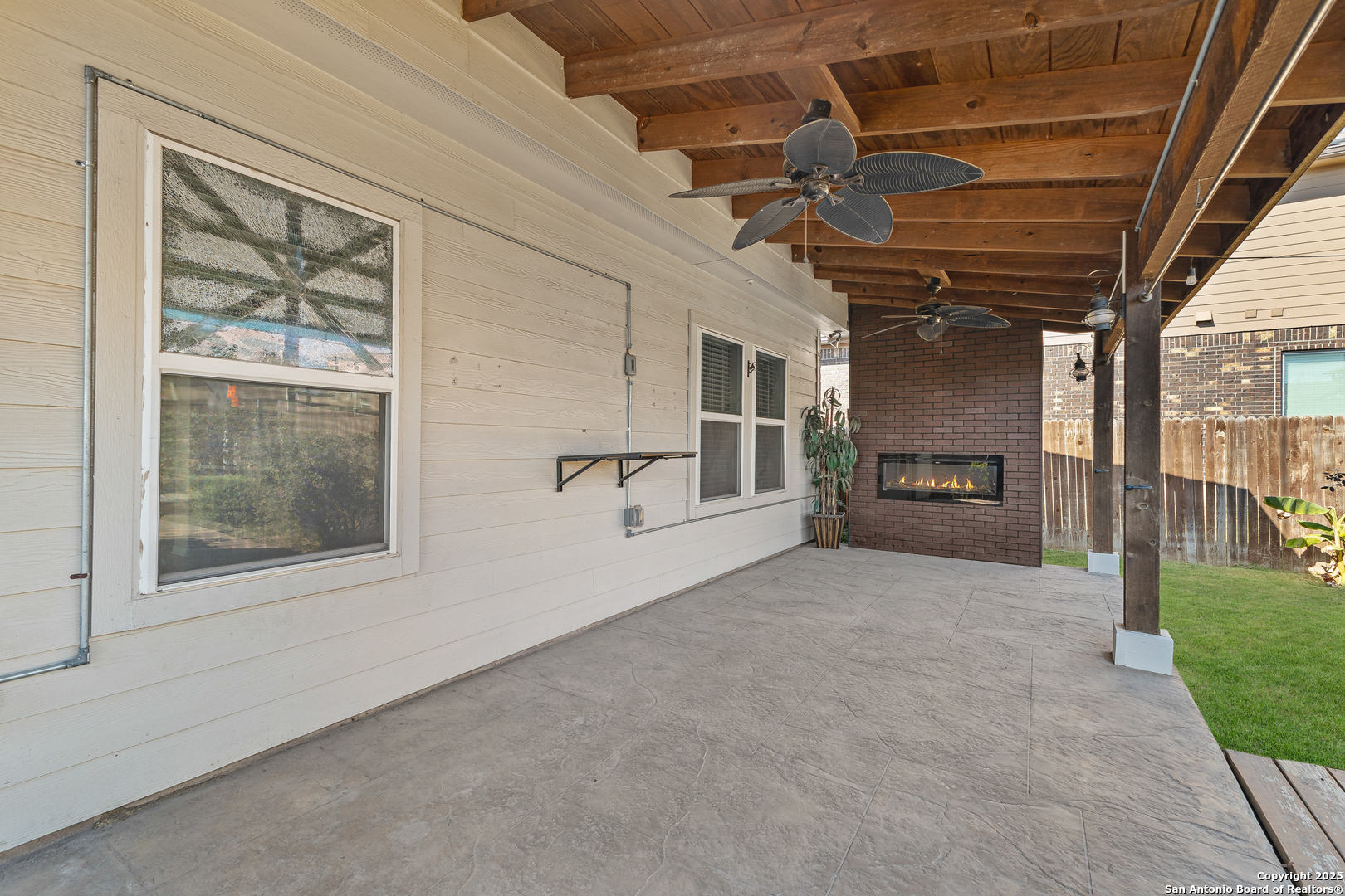 4402 Rucker Park Converse, TX 78109 - Photo 23 of 25 a view of an empty room with a fireplace and windows