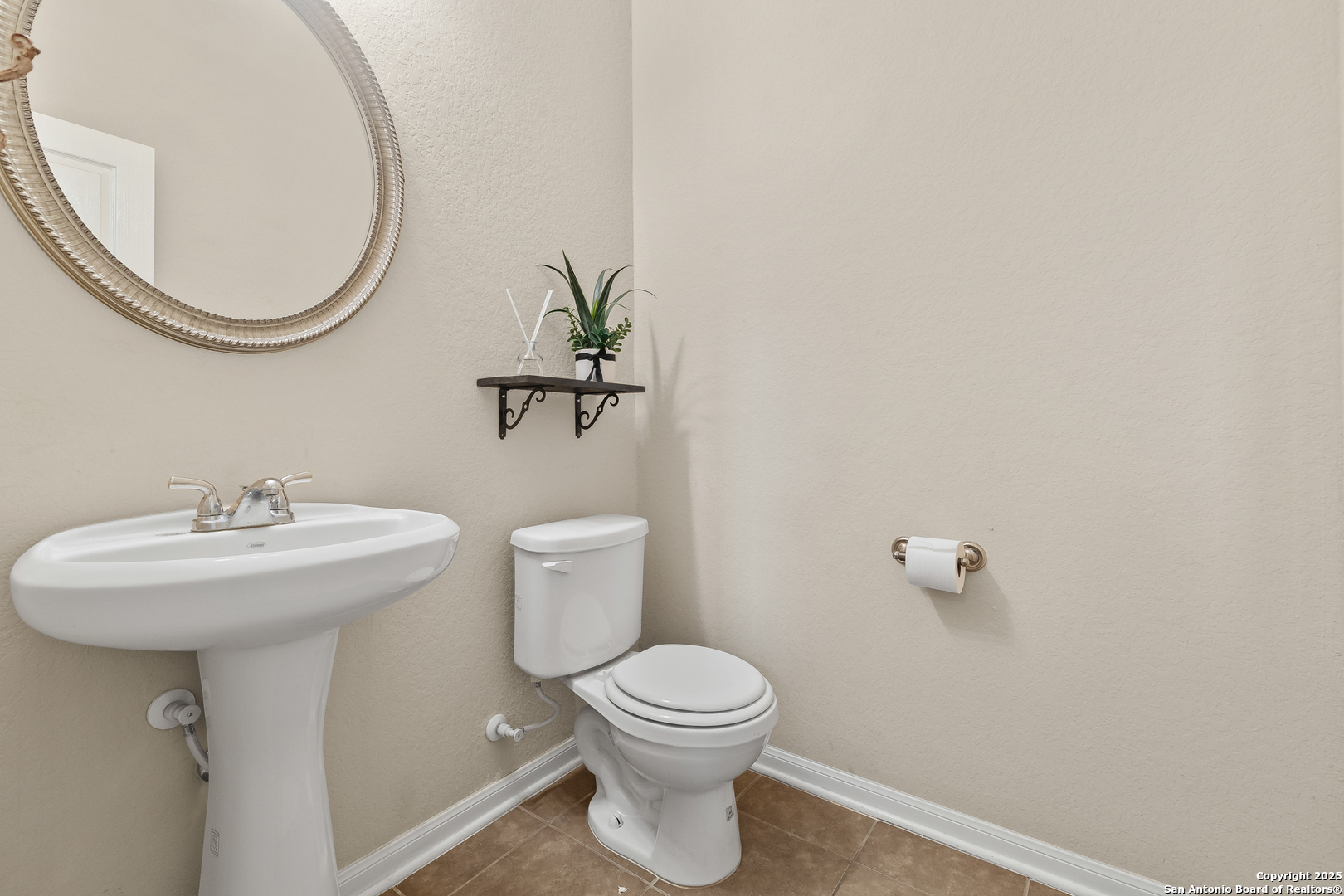4402 Rucker Park Converse, TX 78109 - Photo 4 of 25 a bathroom with a toilet a sink and mirror