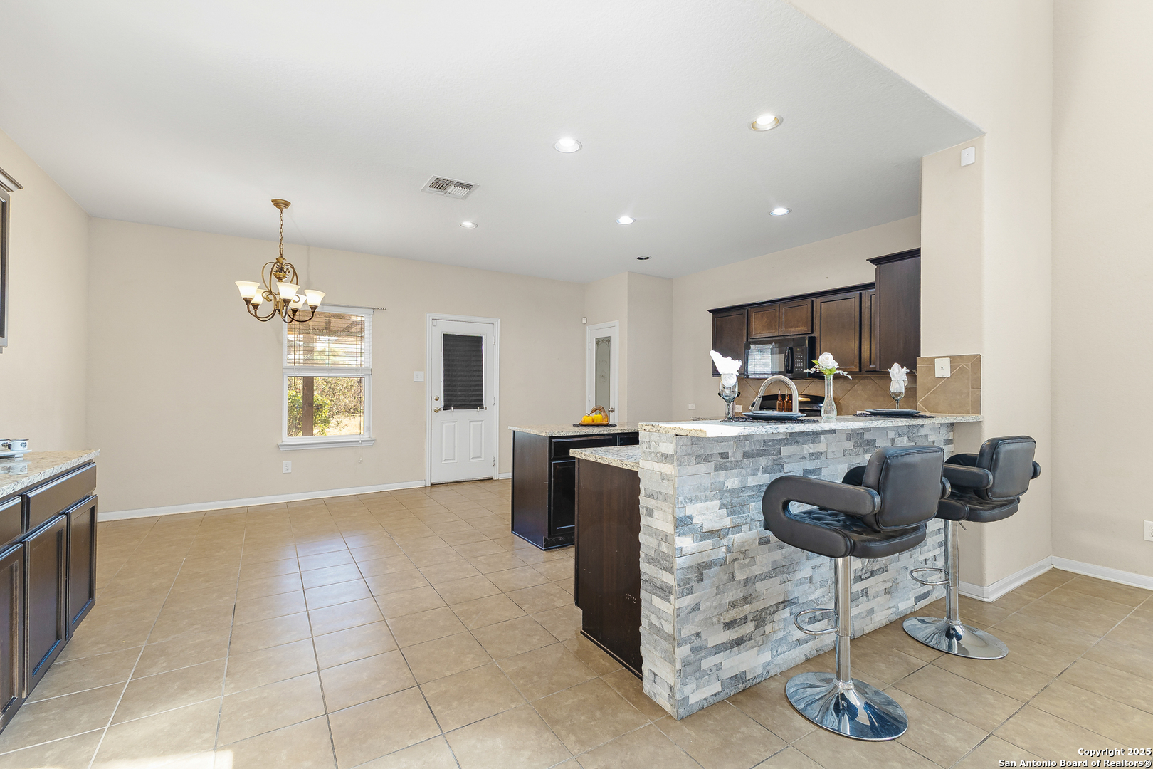 4402 Rucker Park Converse, TX 78109 - Photo 8 of 25 a kitchen with granite countertop a sink cabinets and window