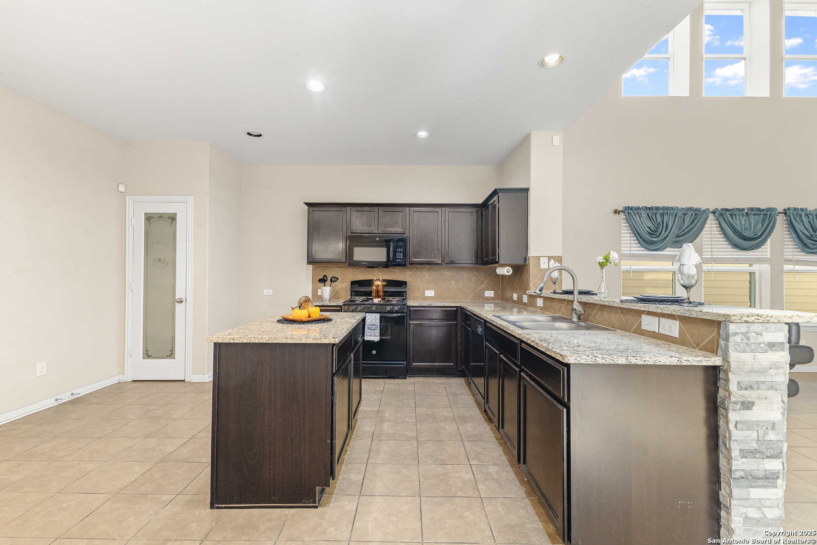 4402 Rucker Park Converse, TX 78109 - Photo 9 of 25 a kitchen with granite countertop a sink and counter top