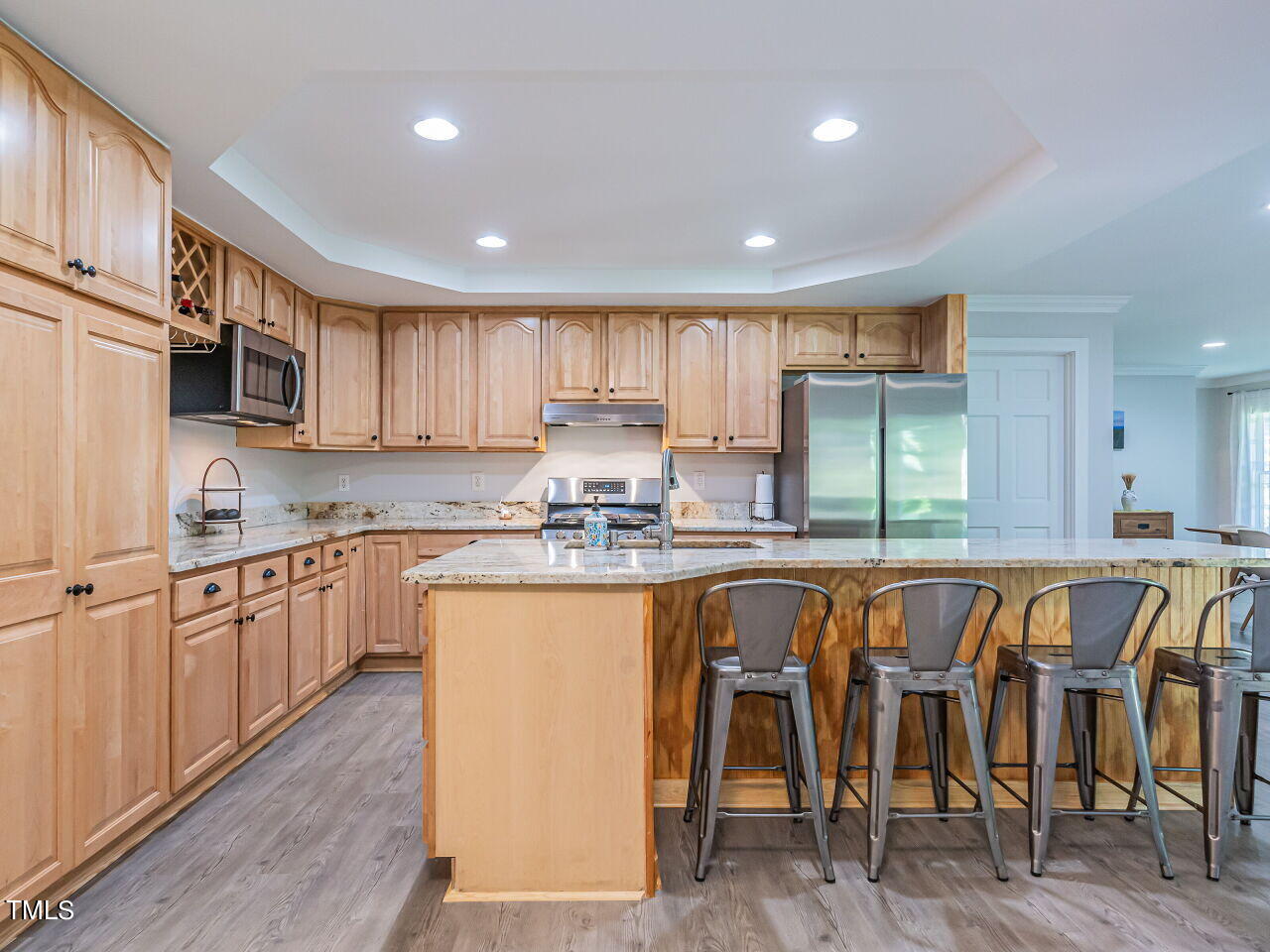 8313 North Creek Run Raleigh, NC 27613 - Photo 14 of 44 Updated Kitchen with granite countertops, stainless steel appliances, massive island and new LVP. Refrigerator conveys.