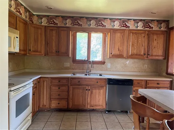a kitchen with a sink stove and cabinets