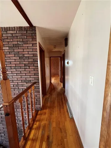 a view of hallway with wooden floor