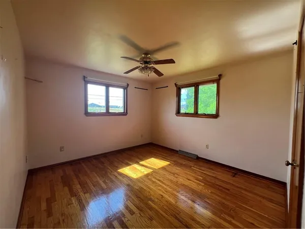 an empty room with a empty space and windows