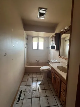 a bathroom with a sink a toilet and mirror
