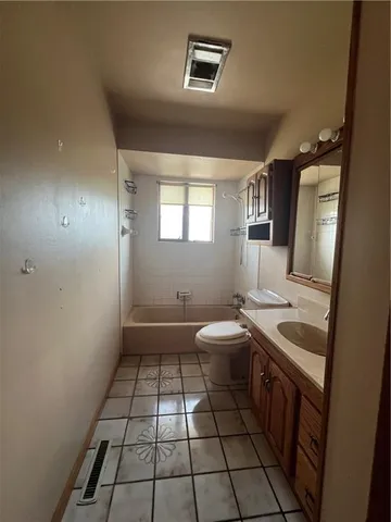 a bathroom with a sink a toilet and mirror
