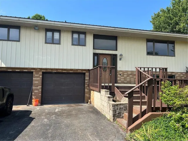 a front view of a house with wooden stairs