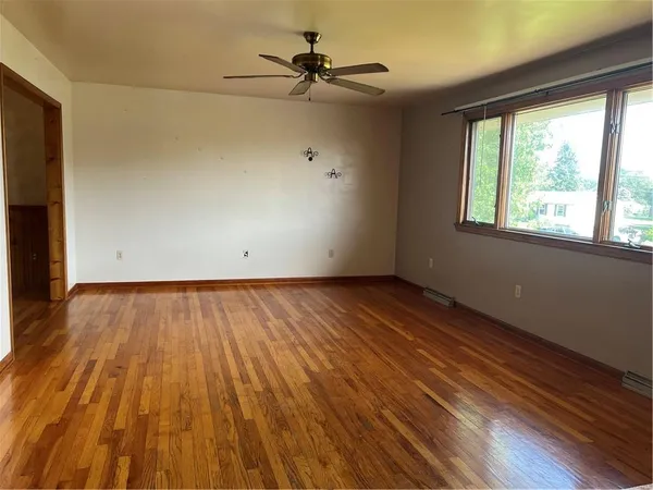 wooden floor in an empty room with a window