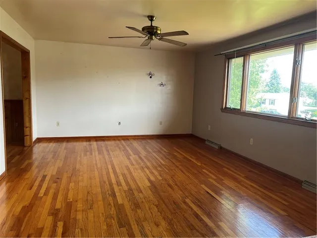 wooden floor in an empty room with a window