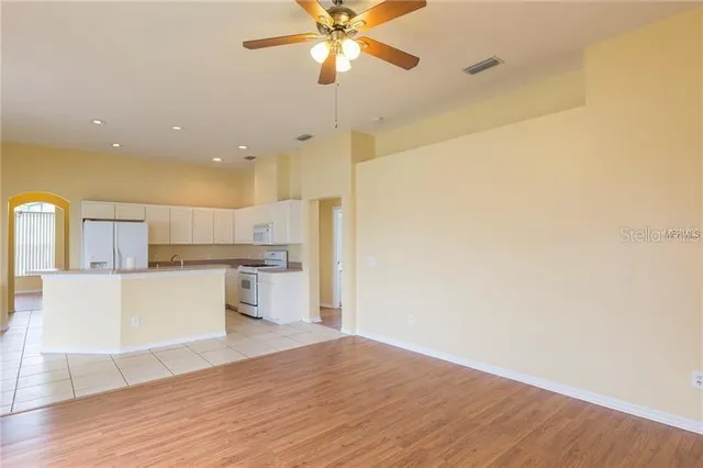 a view of kitchen with granite countertop cabinets and wooden floor