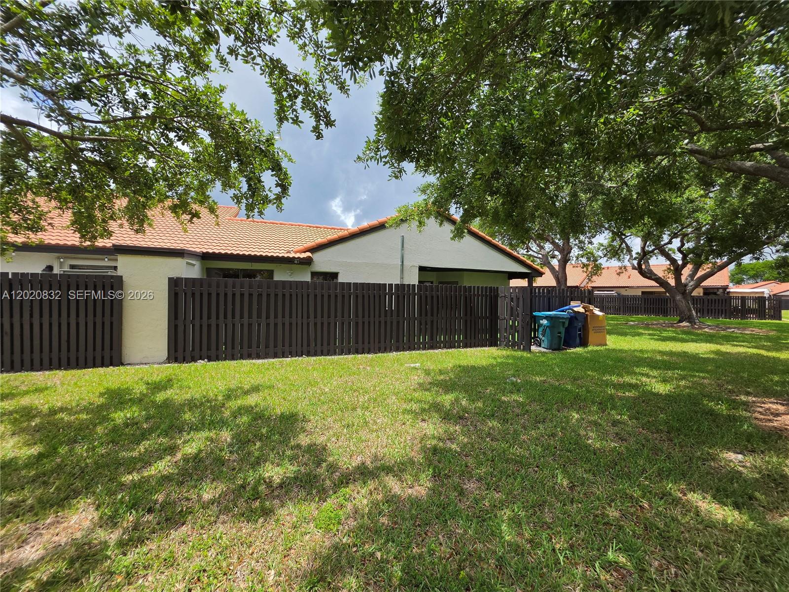 15240 Southwest 45th Terrace, Unit 54F Miami, FL 33185 - Photo 11 of 48 a view of a house with a yard and a large tree