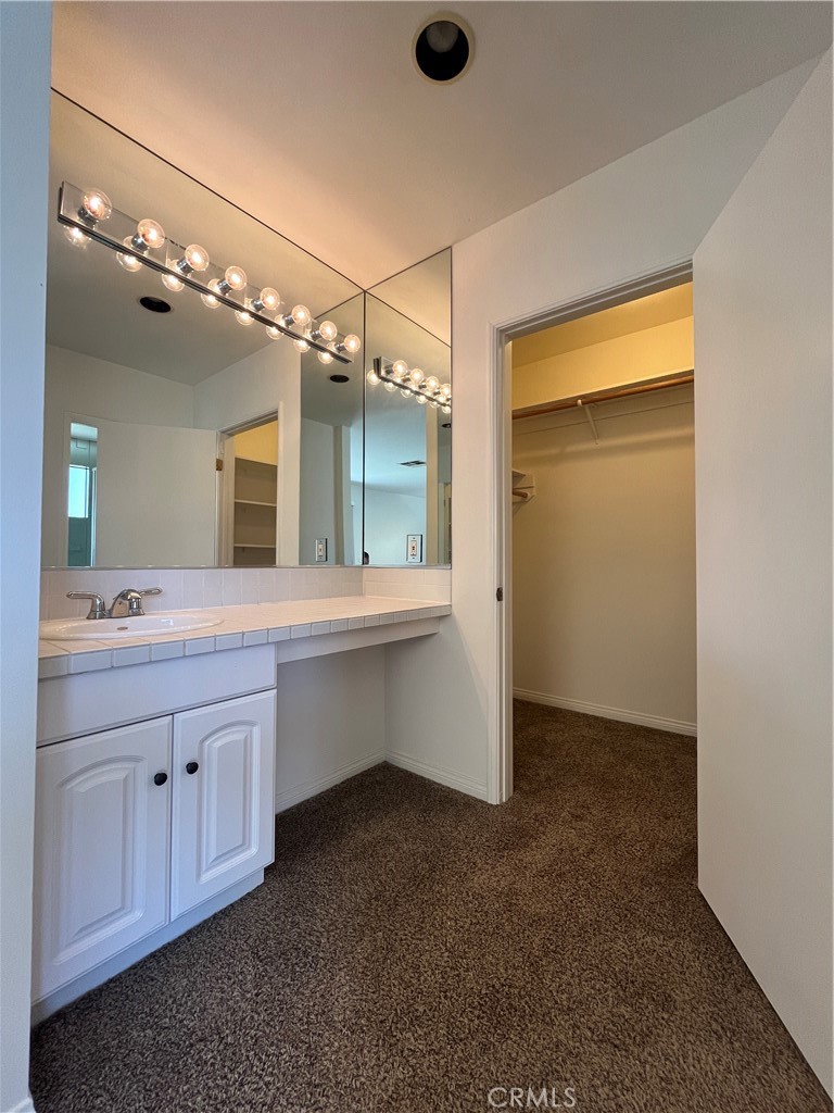 18029 Santa Rita Street Encino, CA 91316 - Photo 14 of 20 a bathroom with a double vanity sink and a mirror