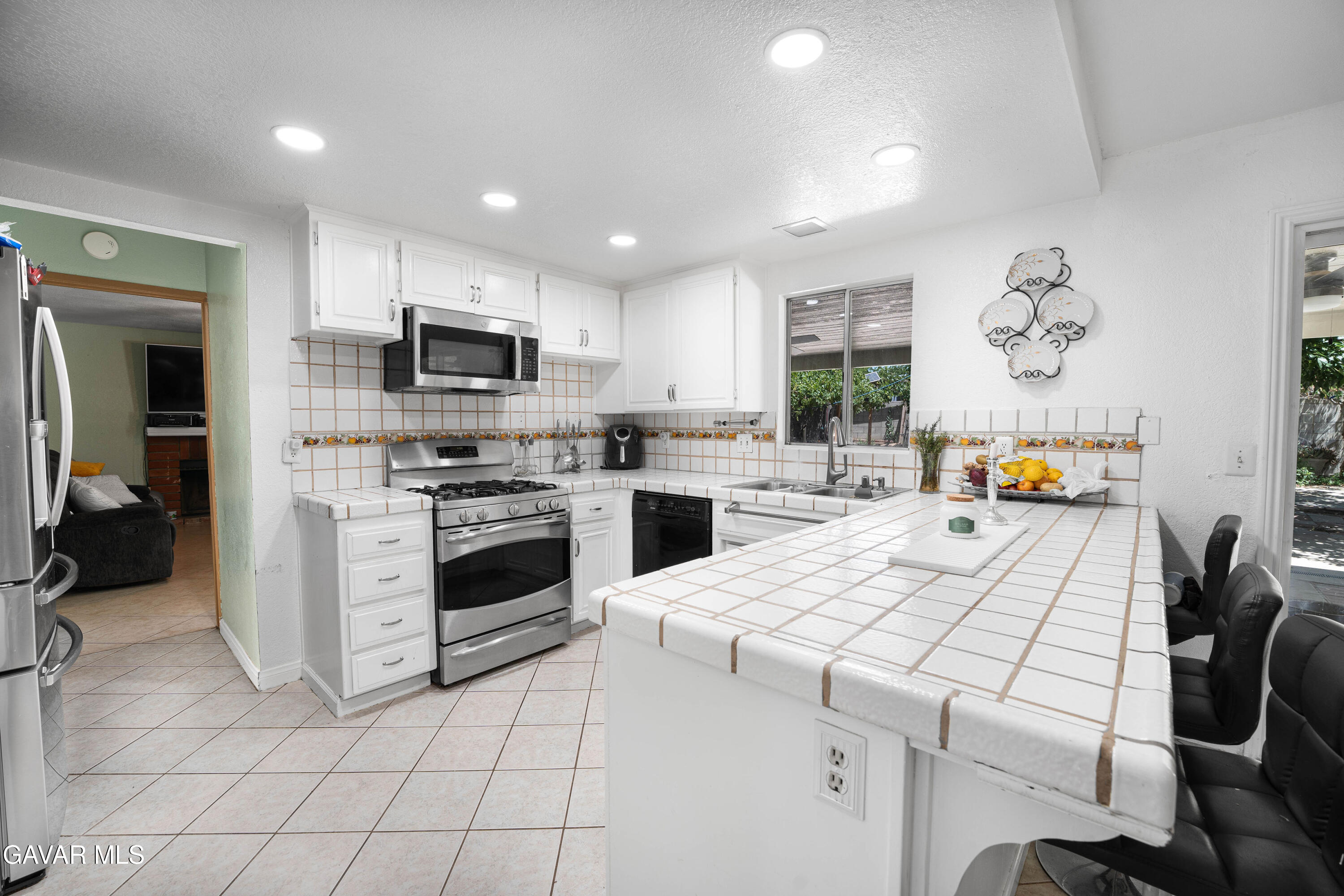 5009 East Ave R 11 Palmdale, CA 93552 - Photo 9 of 23 a kitchen with a white stove top oven and cabinets