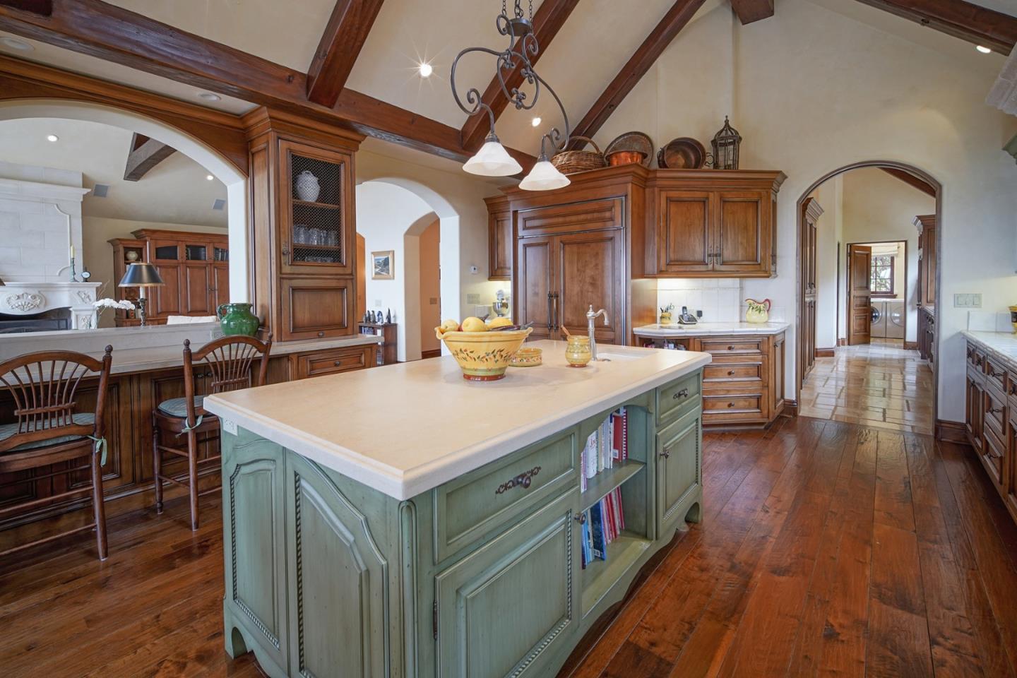 1606 Sonado Road Pebble Beach, CA 93953 - Photo 15 of 47 a kitchen that has a lot of cabinets in it
