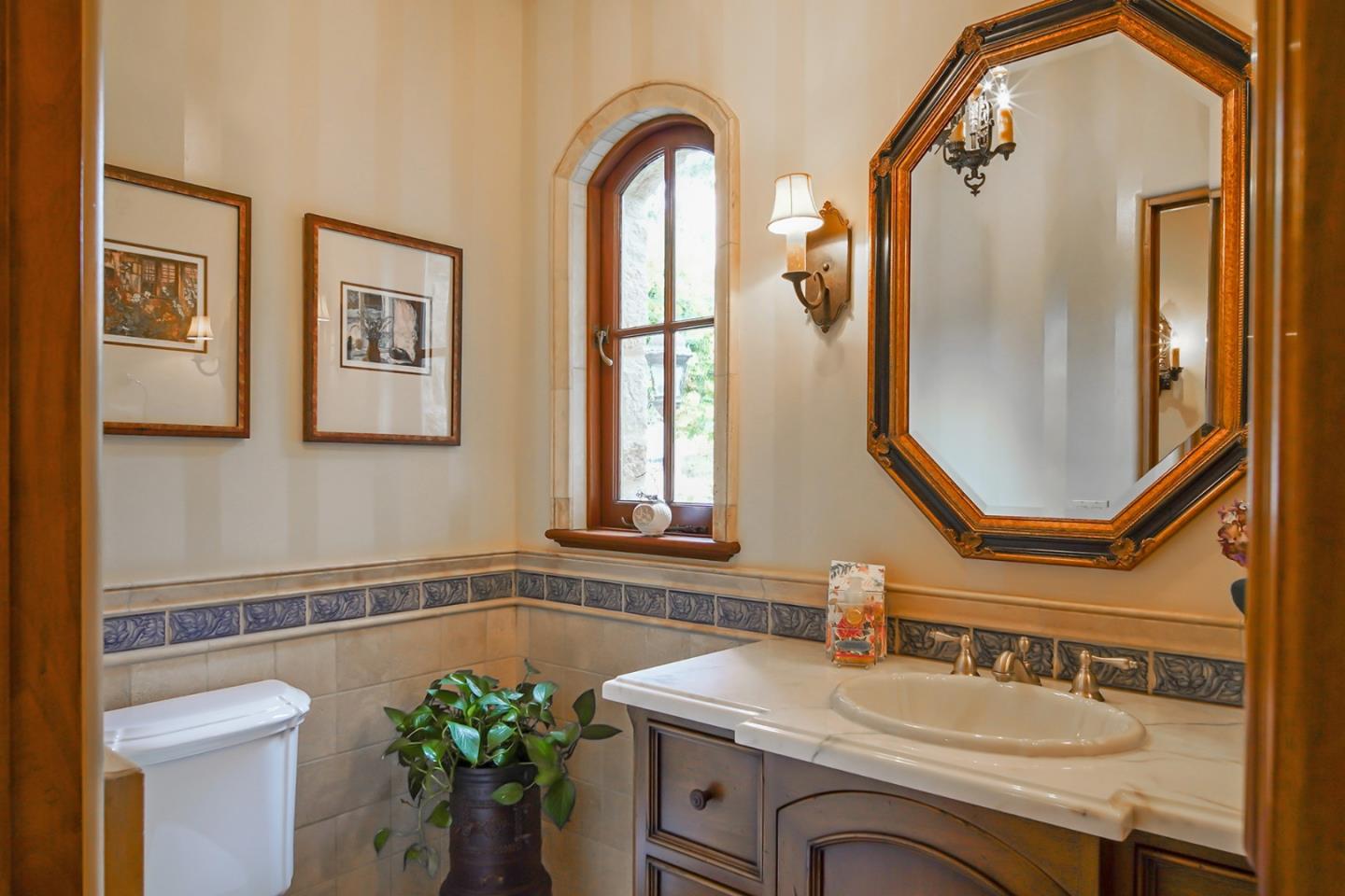 1606 Sonado Road Pebble Beach, CA 93953 - Photo 23 of 47 a bathroom with a granite countertop sink a mirror a vanity and a window