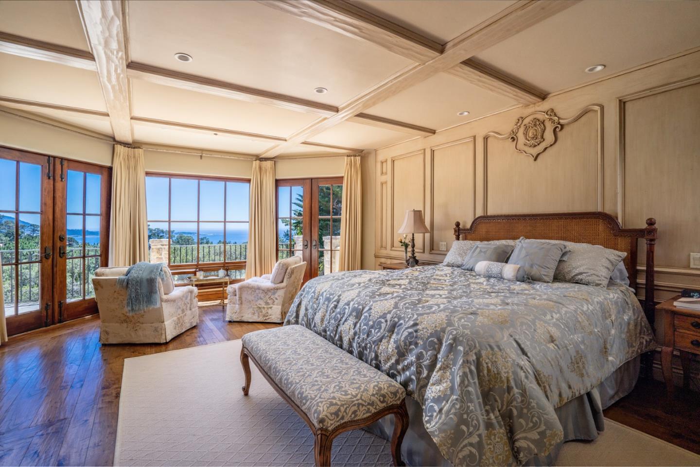 1606 Sonado Road Pebble Beach, CA 93953 - Photo 24 of 47 a spacious bedroom with a bed couch and wooden floor