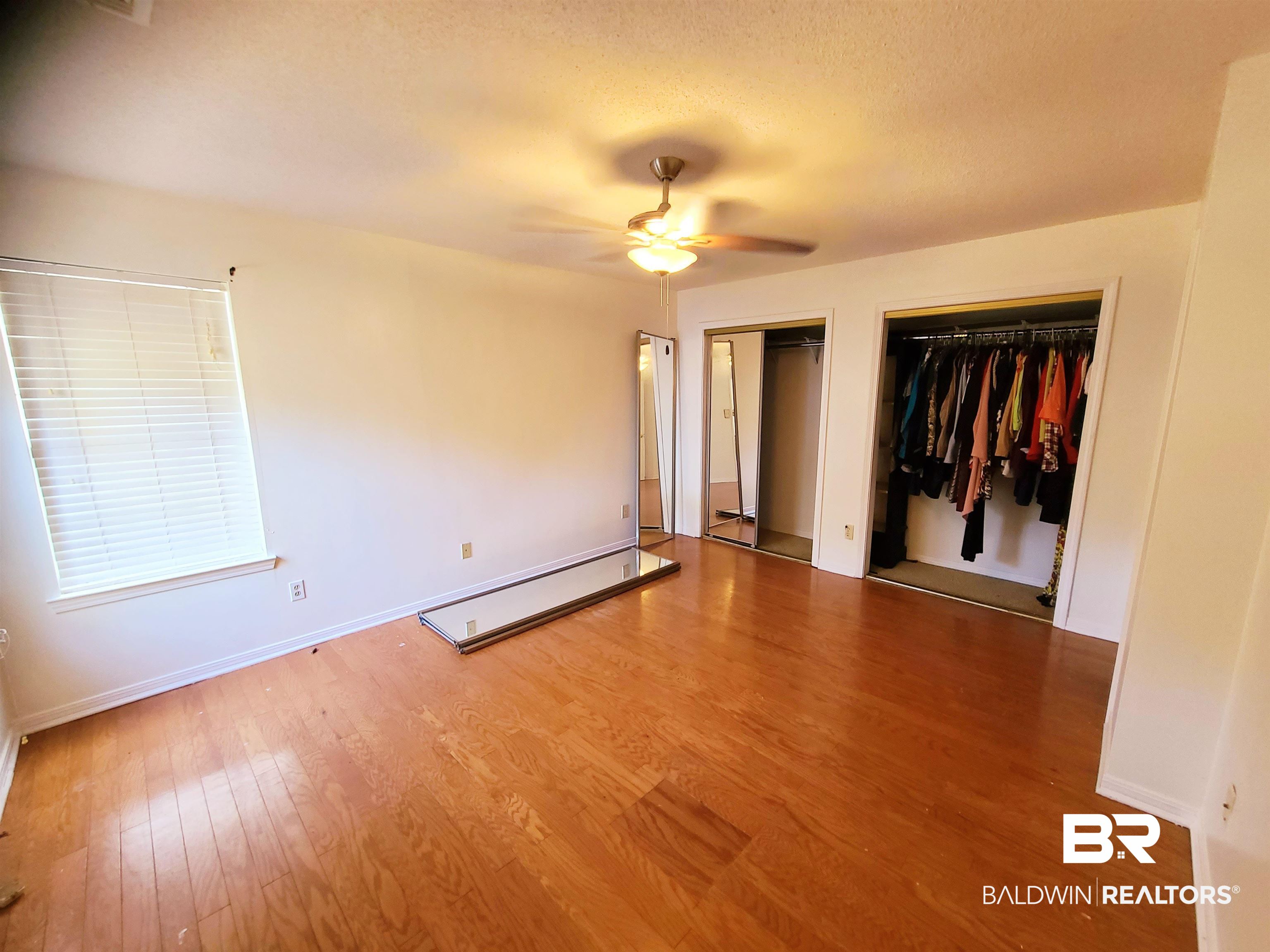 123 Melanie Loop Daphne, AL 36526 - Photo 13 of 17 Unfurnished bedroom featuring light wood-type flooring, a closet, a ceiling fan, and a textured ceiling