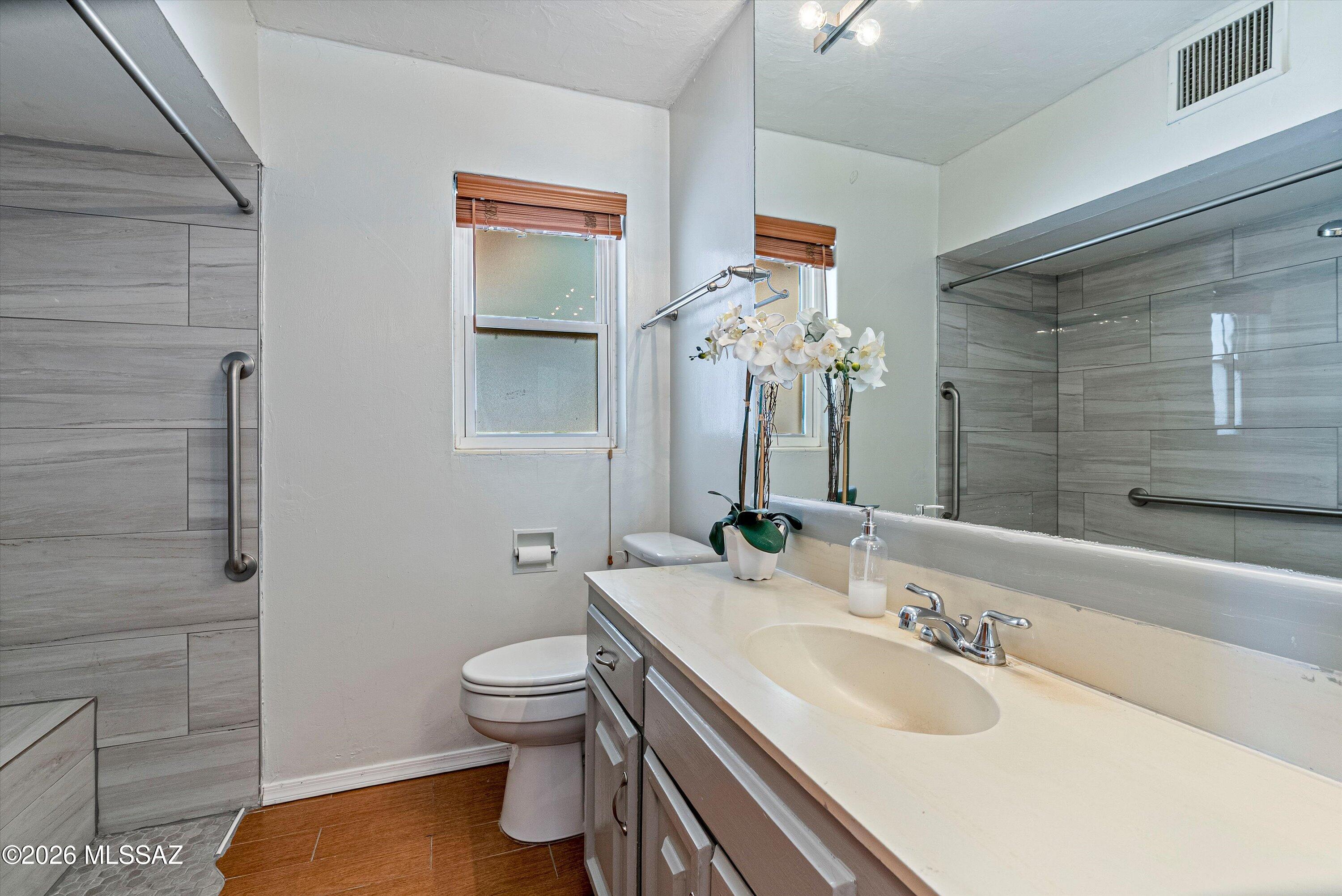 2107 East Lind Road Tucson, AZ 85719 - Photo 30 of 43 a bathroom with a granite countertop sink toilet and shower