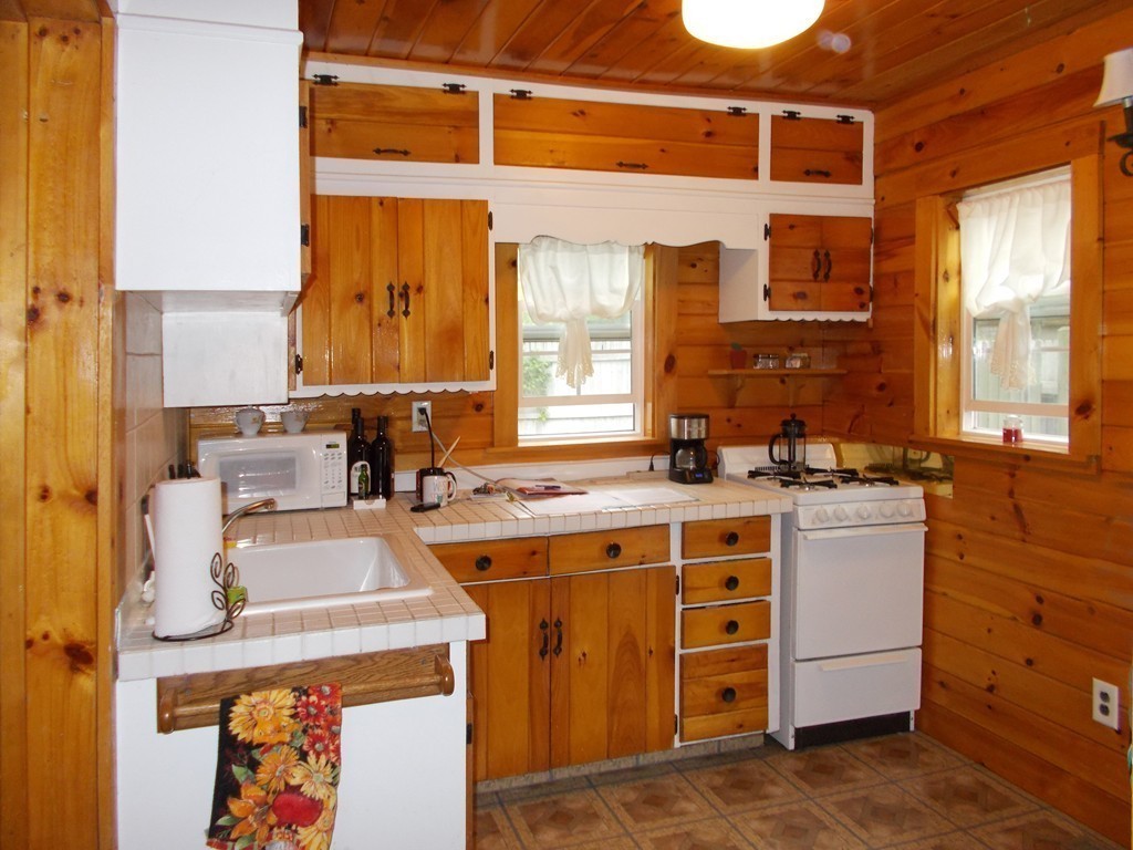 136 Barker Road Wareham, MA 02538 - Photo 8 of 13 a kitchen with a stove a sink and a refrigerator