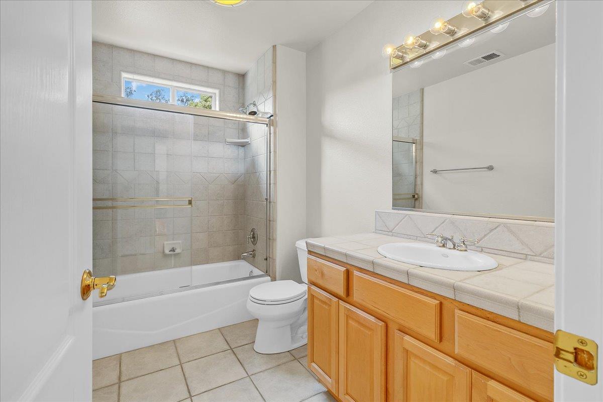 817 Lewis Road Watsonville, CA 95076 - Photo 16 of 27 a bathroom with a granite countertop sink a toilet and shower