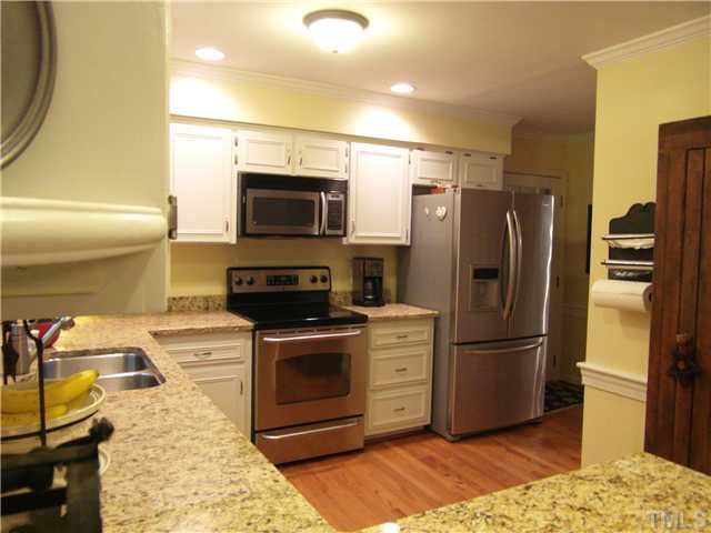 11805 Coachmans Way Raleigh, NC 27614 - Photo 8 of 25 a kitchen with stainless steel appliances granite countertop a refrigerator stove and microwave