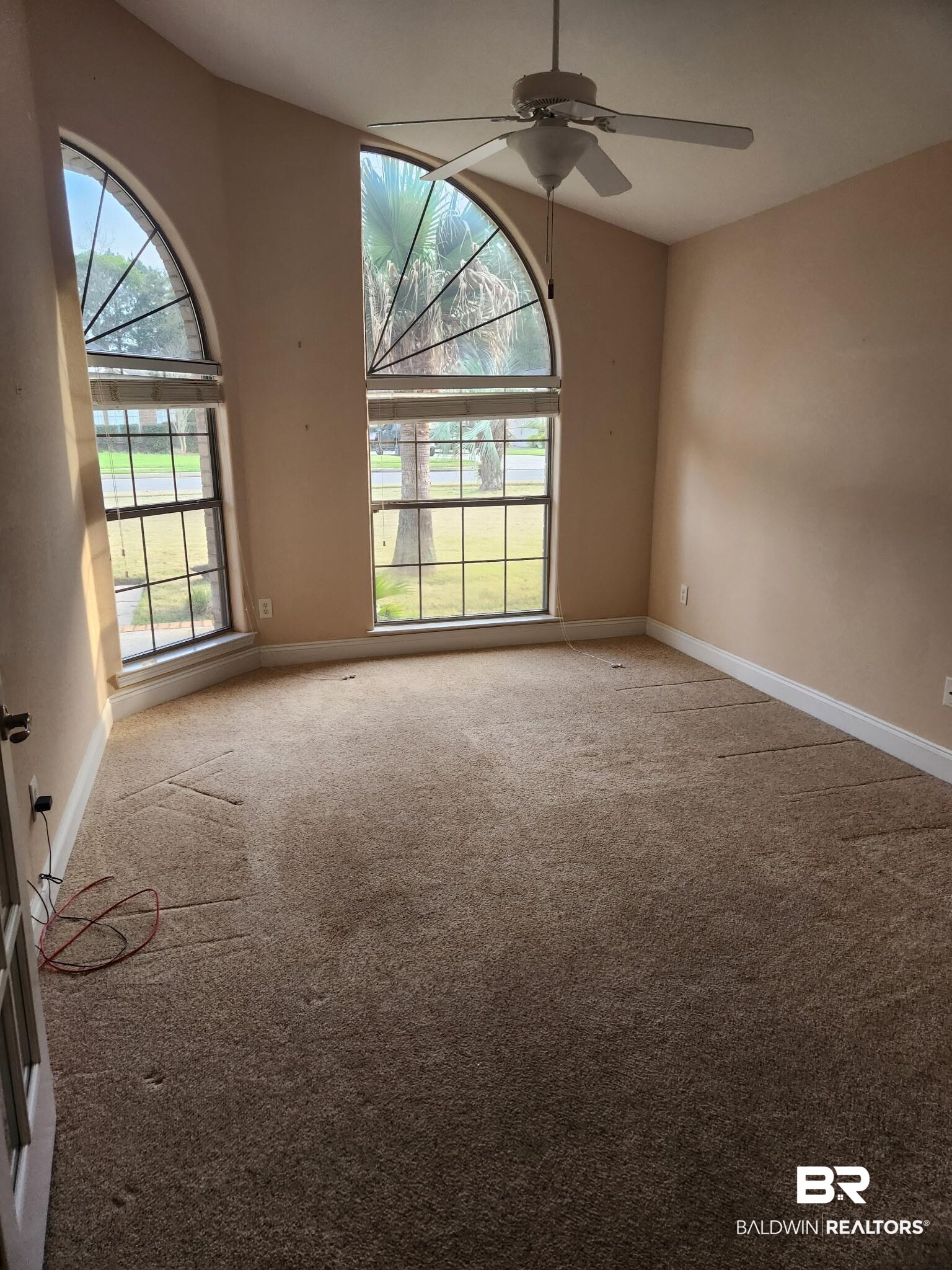 9425 Autauga Bend Daphne, AL 36526 - Photo 7 of 15 Spare room with light carpet, a ceiling fan, and healthy amount of natural light