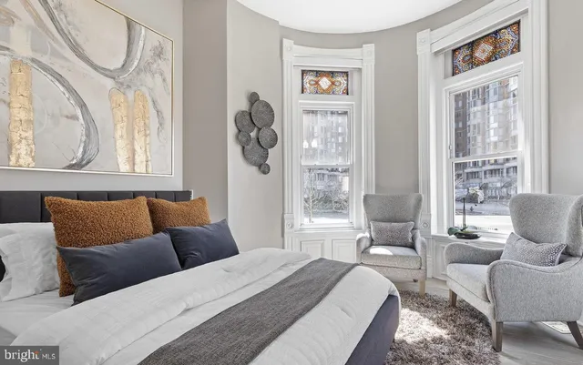 a bedroom with a bed couch and window