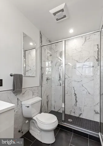 a bathroom with a toilet and a shower