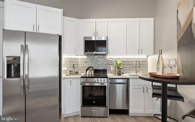 a kitchen with a stove and a refrigerator