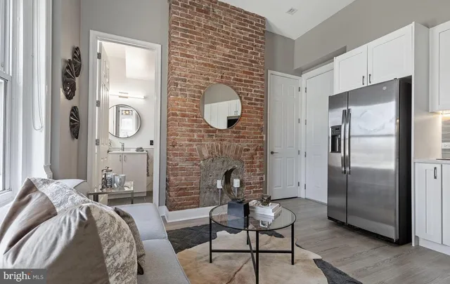a living room with furniture and a fireplace