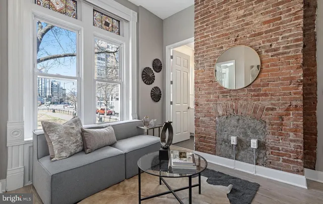 a living room with furniture and a painting on the wall